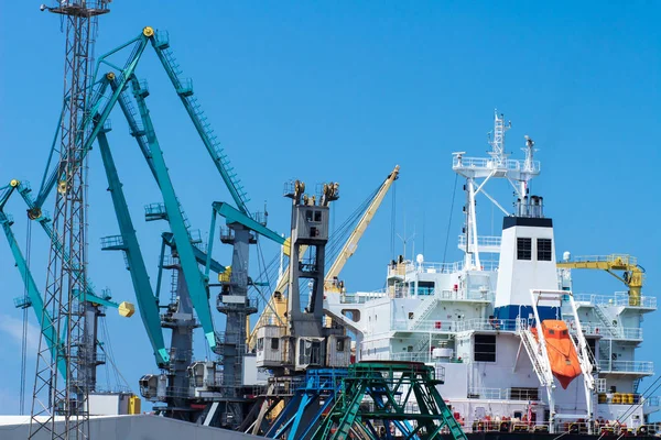 Container terminal. Cranes in sea port. Logistic dockyard cargo.