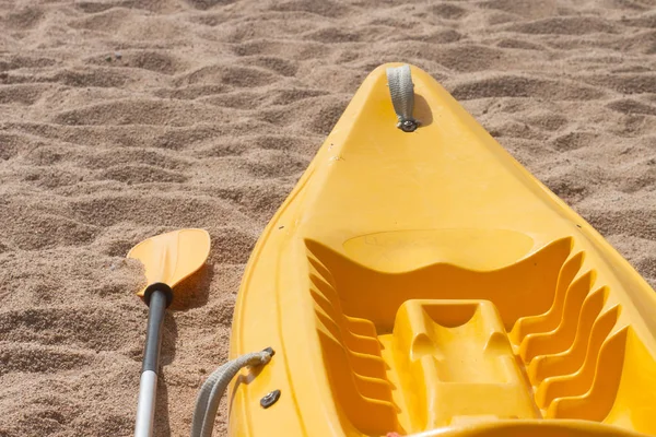 Kayaking on sea. Kayak and oar on sandy beach.