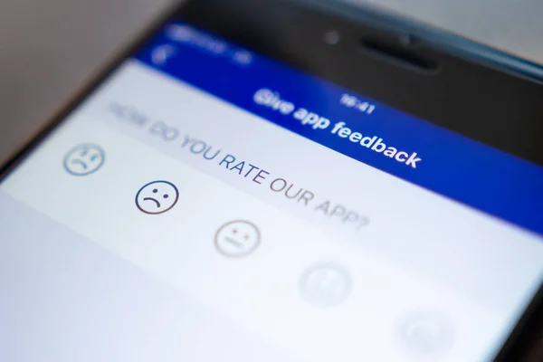 Give app feedback on phone screen — Stock Photo, Image