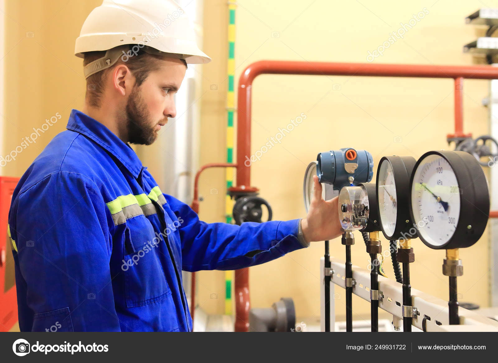Inspector checking pressure gauges on heating boiler system Stock Photo