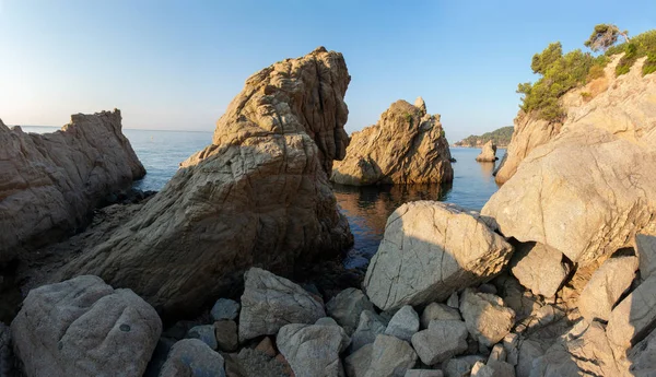 Rocas en la costa de Lloret de Mar, España. Acantilado en la playa rocosa — Foto de Stock
