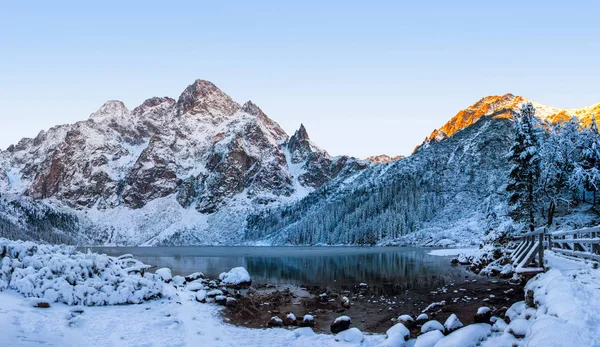 Winter mountains. Snowy mountain on Morskie Oko icy lake. Winter