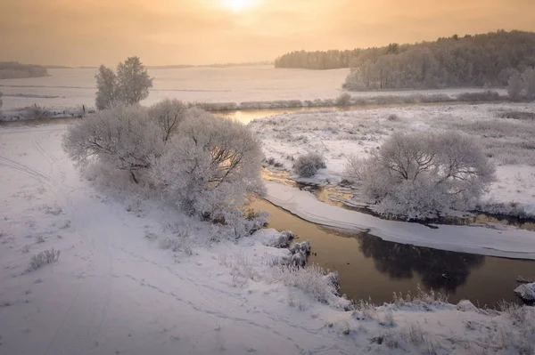 Winter sunrise. Beautiful winter scene on river in frosty mornin