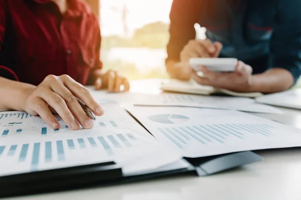 Business startup analysis summary report graph and using a calculator to calculate the numbers.