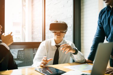 Genç iş insanlar test sanal gerçeklik Vr kulaklık teknolojisi meslektaşım Office ile.