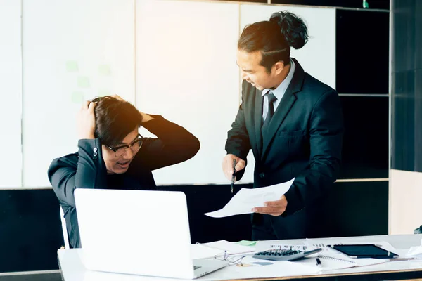 Boss shouting to employee while mistake working.