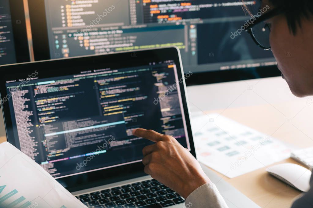 Professional development programmer cooperating meeting programming website working a software in office room.