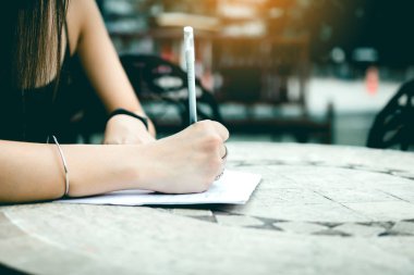 Asyalı kadın el dış outle masada alışveriş listesine kontrol