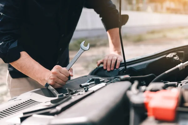 Araba tamircisi bir İngiliz anahtarı motor ve m kontrol etmek hazır tutuyor — Stok fotoğraf