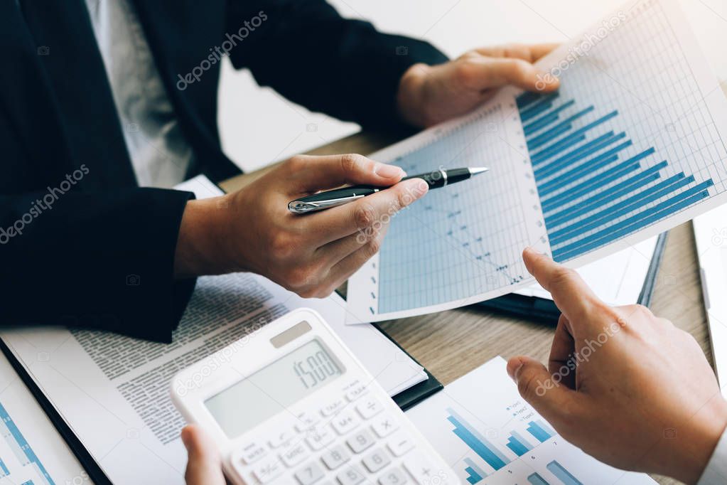 Businessman looking graph and summary report on document finance