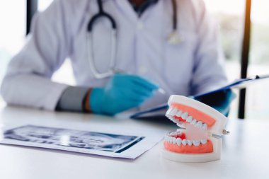 Rapor kağıt klinik odasında çalışan Asya dişçi adam.