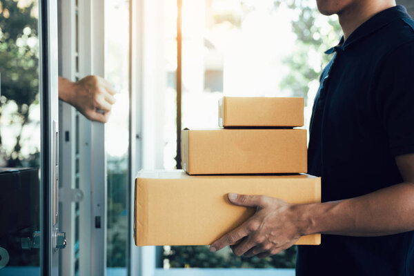 Close up of hand recipient of the goods is opening the house doo