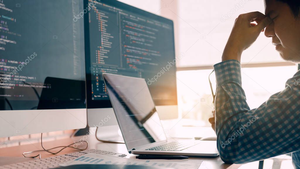 Male programmers are stressed at the office while working analyz