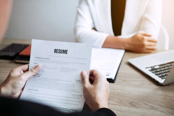 Job applicants are holding a resume document in the job intervie