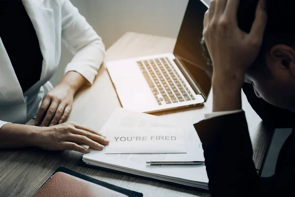 Female manager handed out a sack to the male employee while bein — Stock Photo, Image