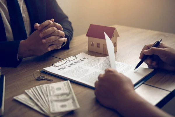 New home buyers are signing a home purchase contract at the agen