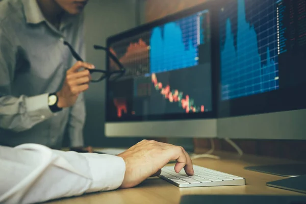 Two business stock brokers stress and looking at monitors displa