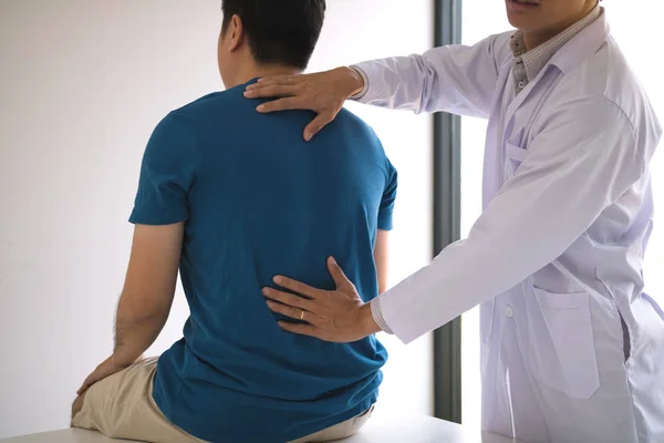 Physical therapists are using hands to check the back of the pat Royalty Free Stock Photos
