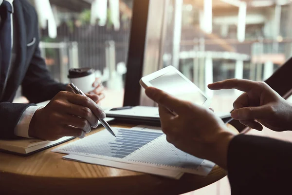 Business partnership coworkers using a tablet to chart company f — Stock Photo, Image