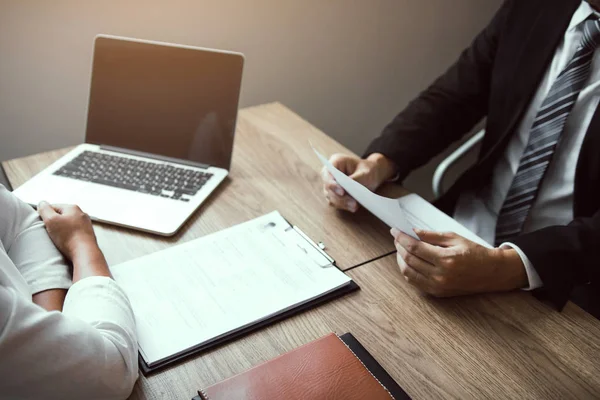 Job applicants are holding a resume document in the job intervie