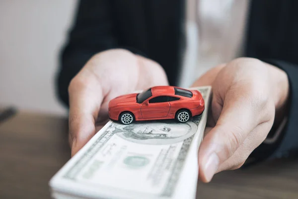 Autoverkäufer überweisen Kunden Bargeld mit Modellautos — Stockfoto