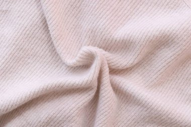 Örülmüş pastel pembe süveter dokusu, yakın çekim bej pembe örgü kumaş dokusu.