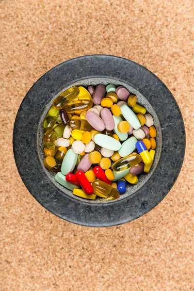 Bowl of multicolored pills addiction concept