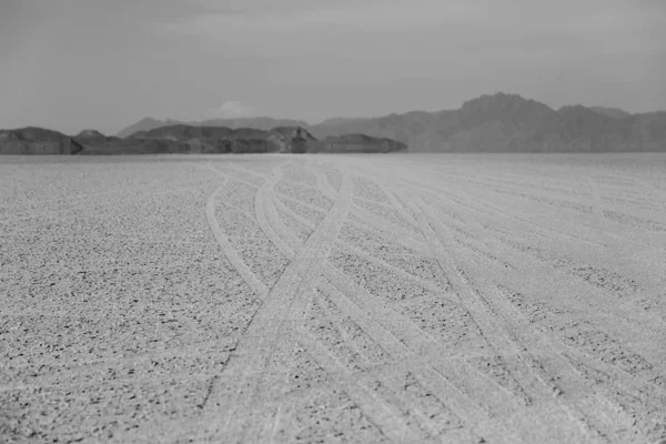 Tire tracks running across the black rock desert playa