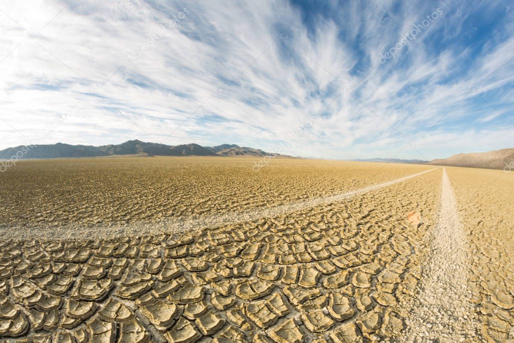 Tire tracks running across the black rock desert playa