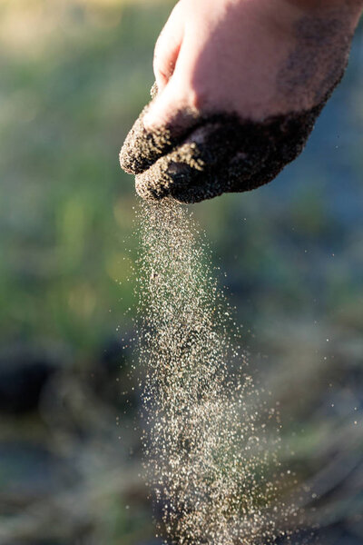 Sifting sands falling from a childs hand