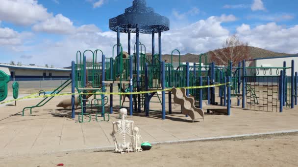 Adult Child Skeleton Sit Playground Closed Covid — Video Stock