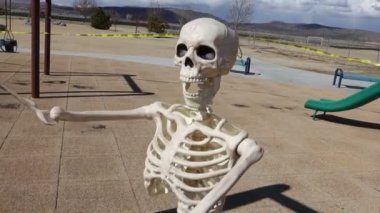 Close up adult skeleton tracked panned movement swinging slow motion