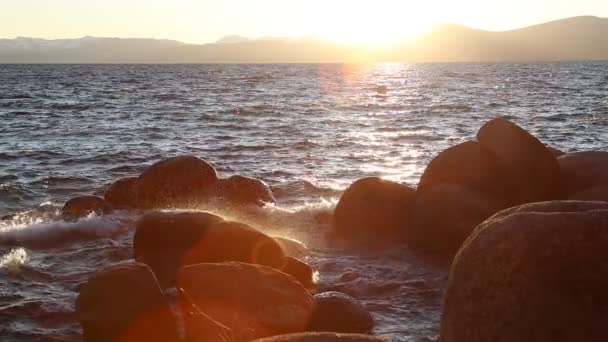 Slow Motion Waves Hitting Rocks Sunset Sun Flared Sand Harbor — Wideo stockowe