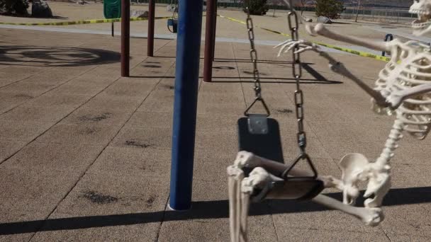 Close Happy Adult Skeleton Side View Swinging Playing Empty Park — ストック動画