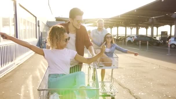 Young People Having Fun Boys Pushing Carts Girls — Stock Video