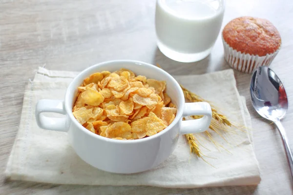 corn flakes with jug of milk and banana cupcake