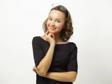 Güzel kadın siyah kazak giyen sevimli gülümseme ile samimi ifade var, beyaz izole arka plan üzerinde duruyor.