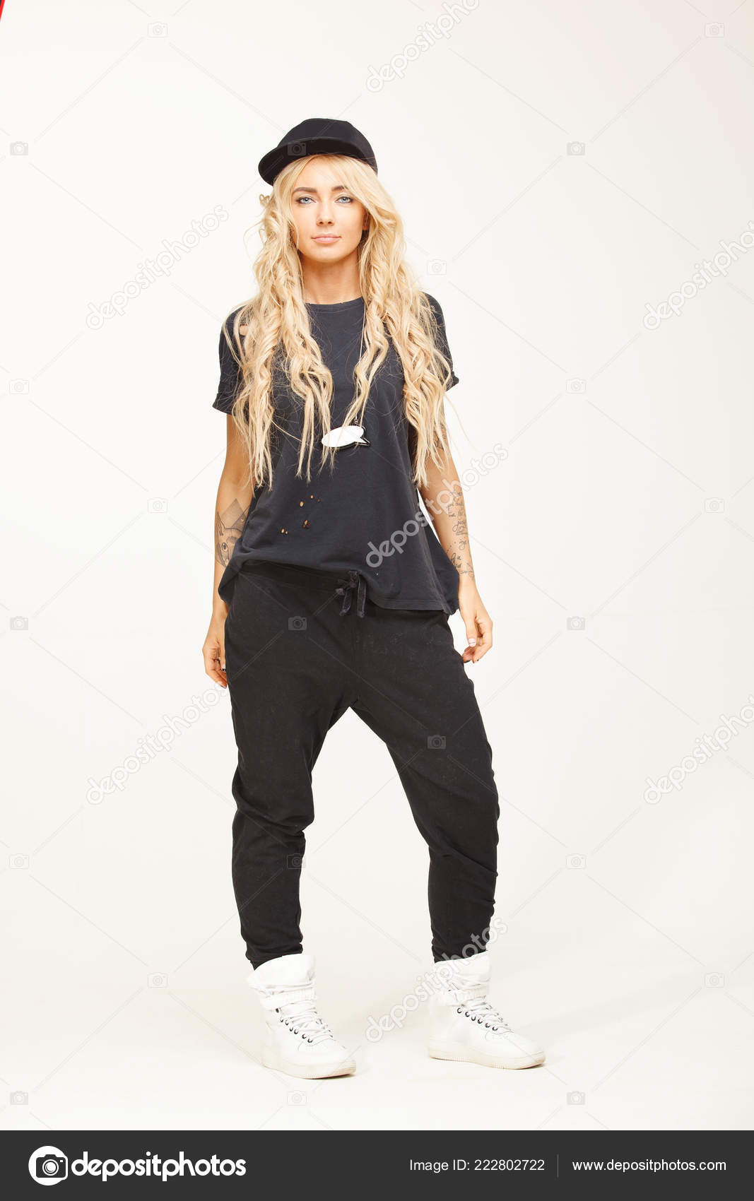Girl with blond hair in stylish swag clothes isolated on