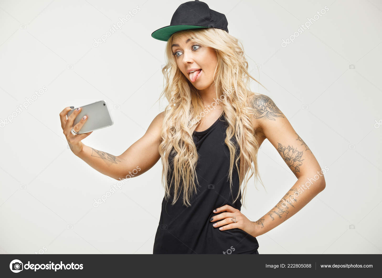 Cute Blonde Girl Grimaces Making Selfie On Phone Over White