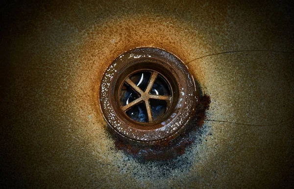 Dirty sink, rusty drain hole.Close up.