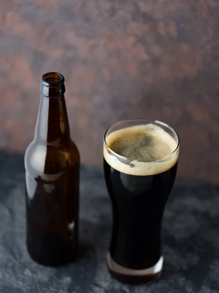 Craft Beer Porter Poured Glass Bottle Concrete Dark Background — Stock Photo, Image