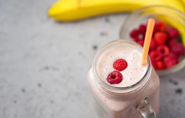 A jar of delicious summer berry smoothie with raspberries and banana