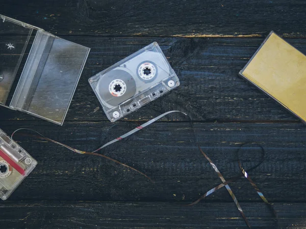 old tapes for a tape recorder on a rustic black table