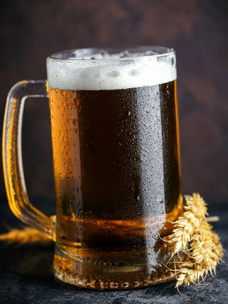 Close-up of a mug of light wheat beer on a dark background
