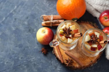 Hot autumn and winter alcoholic drink sangria or cider on the table with Apple, pumpkin, cinnamon, anise clipart