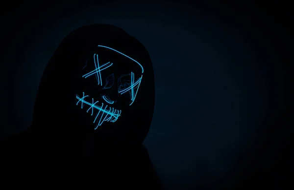 Portrait of an anonymous hacker in a neon mask, Halloween mask