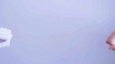 Human fist bumps robot's fist