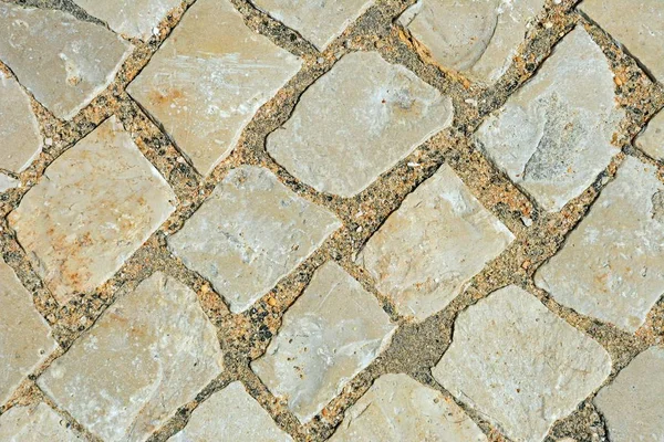 Square stone pavement cobbles, Albufeira, Portugal, Europe.