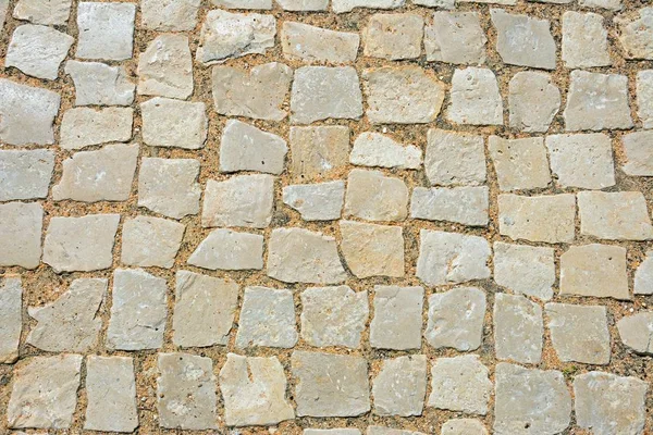 Square stone pavement cobbles, Albufeira, Portugal, Europe.