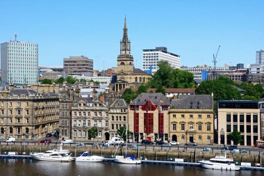 NEWCASTLE, UK  JUNE 11, 2018 - View across the River Tyne towards Newcastle upon Tyne with the church of Saint Willibrord with All Saints clock tower to the centre, Newcastle upon Tyne, Tyne and Wear, England, UK, Western Europe, June 11, 2018. clipart